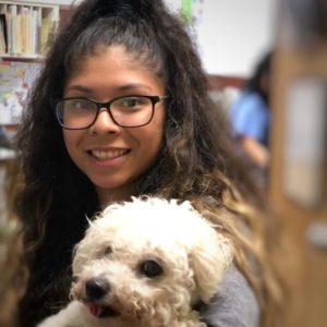 Erika holding a small white dog