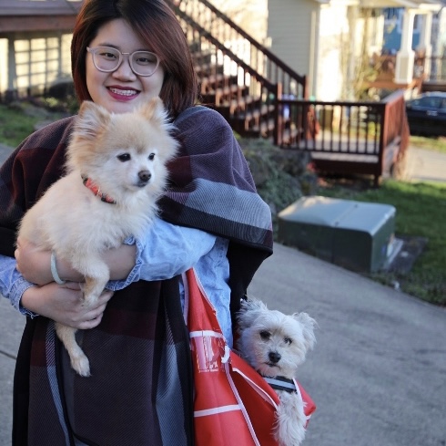 Thuy holding two small dogs